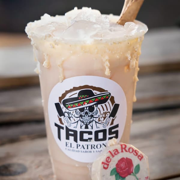 A Tacos El Patron horchata drink with ice and a de la Rosa mazapan candy.