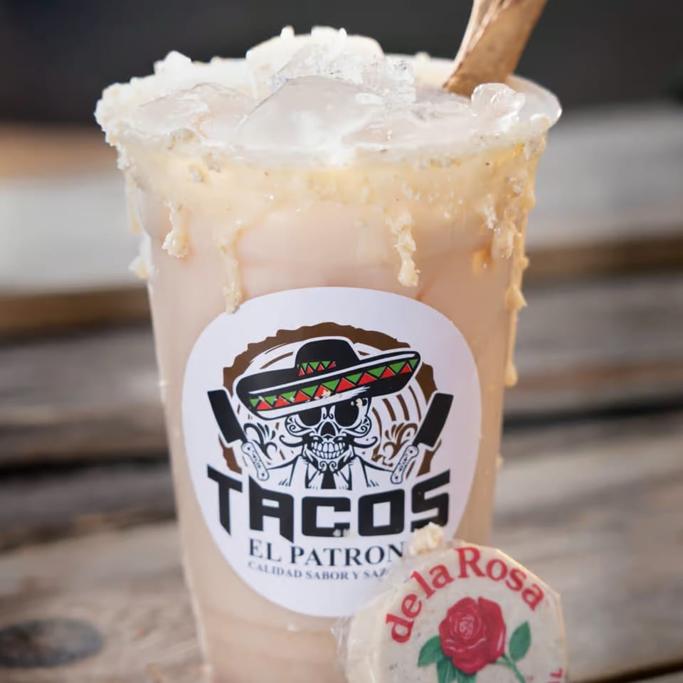 A Tacos El Patron horchata drink with ice and a de la Rosa mazapan candy.