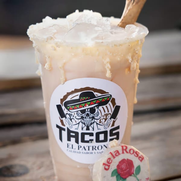 A Tacos El Patron horchata drink with ice and a de la Rosa mazapan candy.
